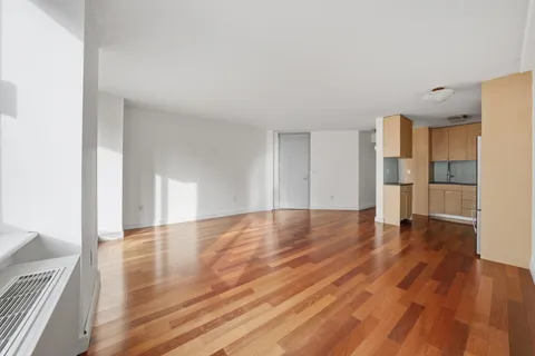 a view of a kitchen with wooden floor and electronic appliances