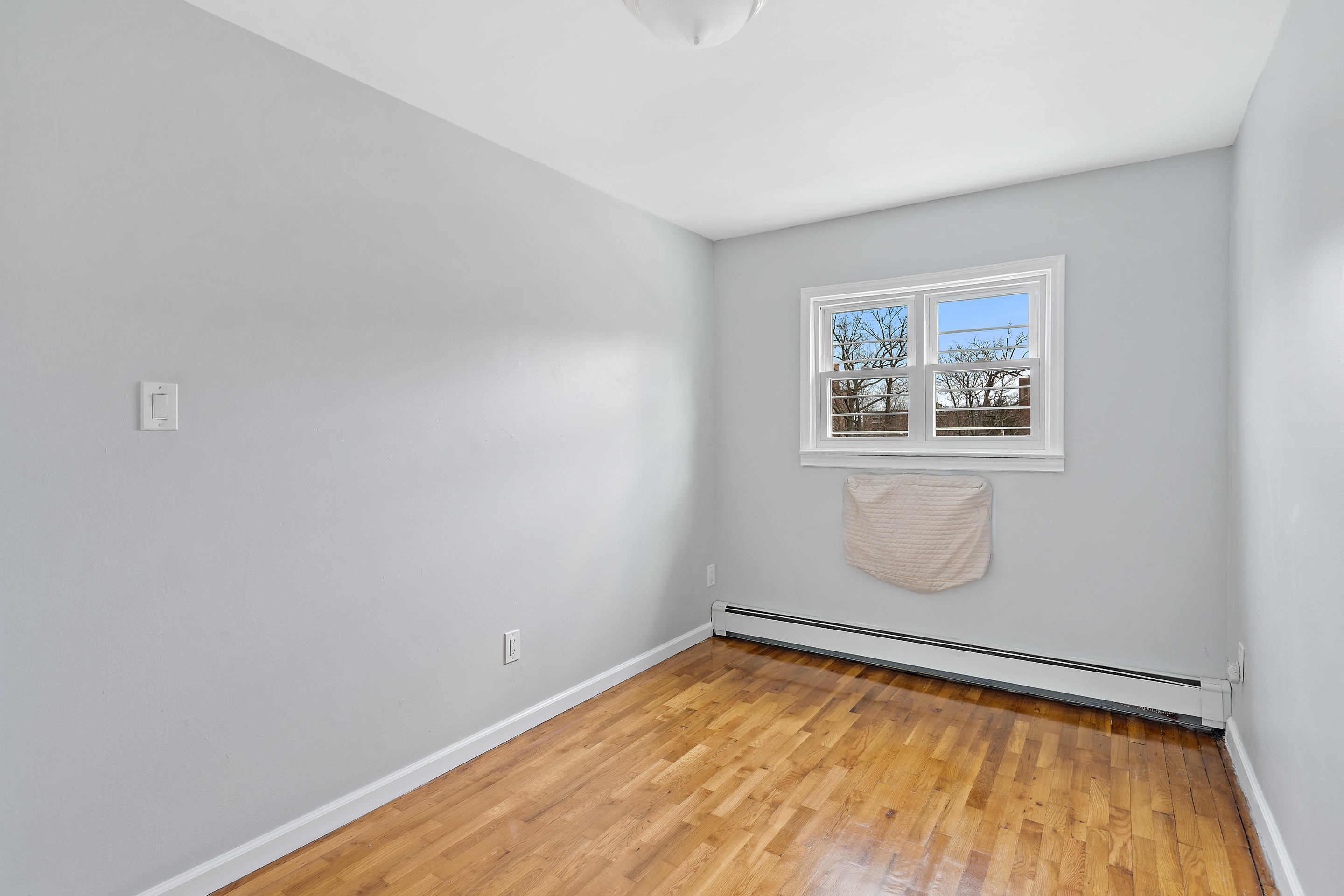 3230 Johnson Avenue, Unit 3 Bronx, NY 10463 - Photo 9 of 21 a view of a room with wooden floor and window