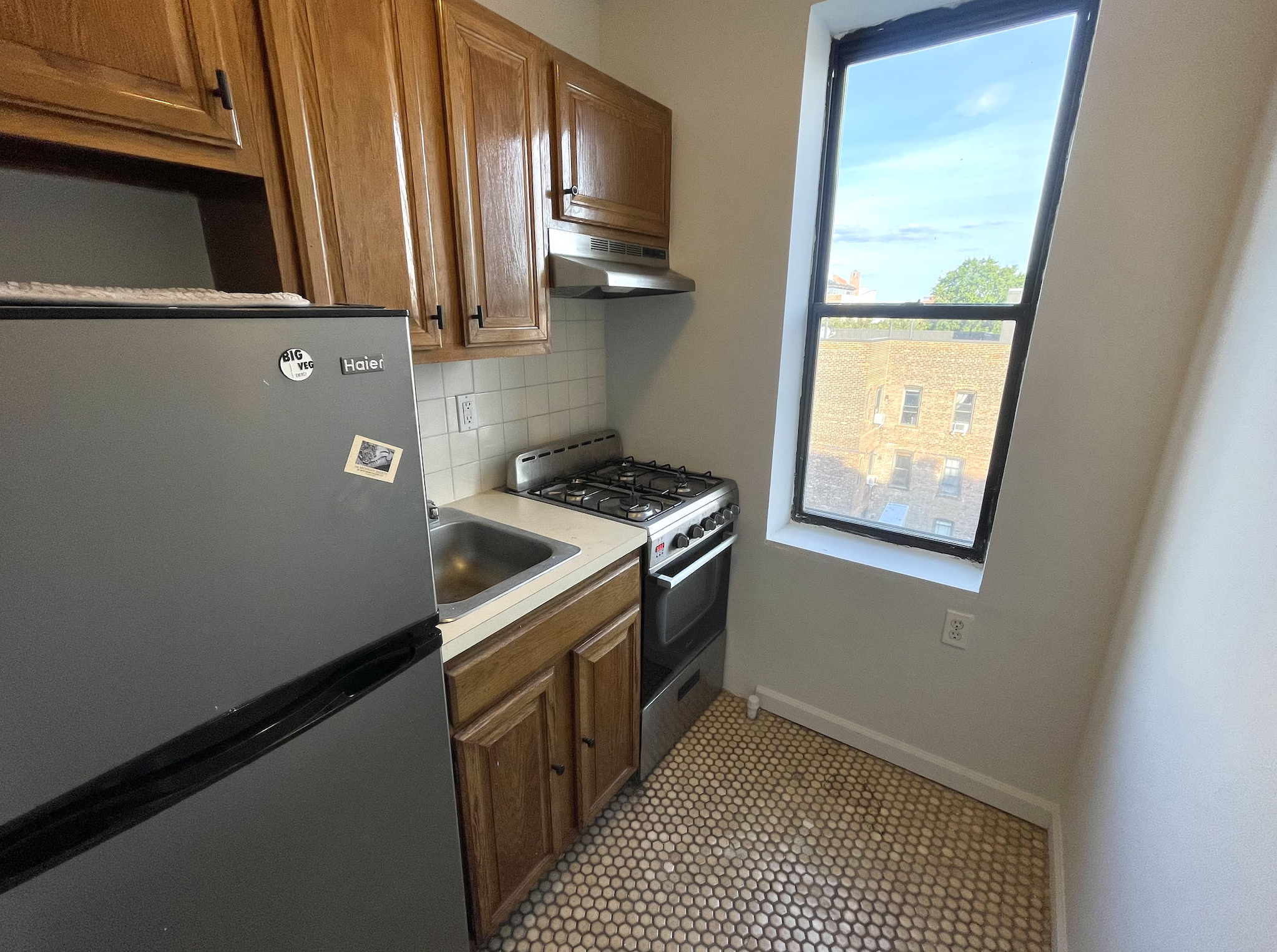 269 Prospect Place, Unit 6A Brooklyn, NY 11238 - Photo 4 of 6 a kitchen with granite countertop a sink a stove and refrigerator