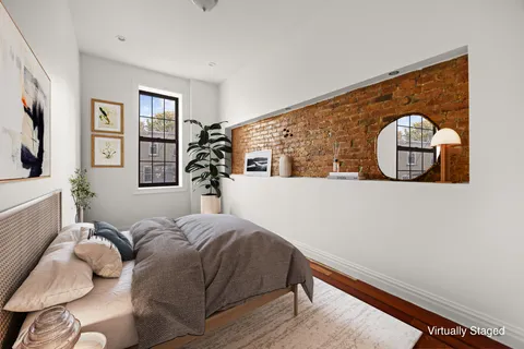 a bedroom with a bed and a painting on the wall