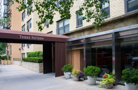 a view of a house with a potted plant and floor to ceiling window and potted plants