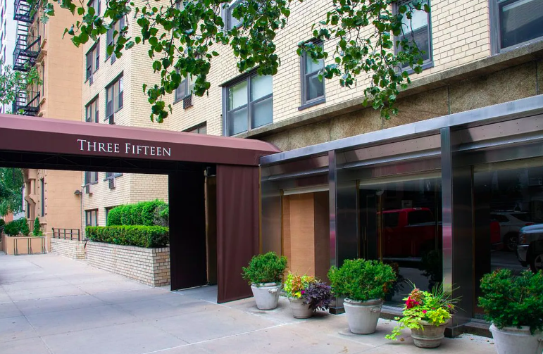 315 East 69th Street, Unit 4E Manhattan, NY 10021 - Photo 6 of 8 a view of a house with a potted plant and floor to ceiling window and potted plants