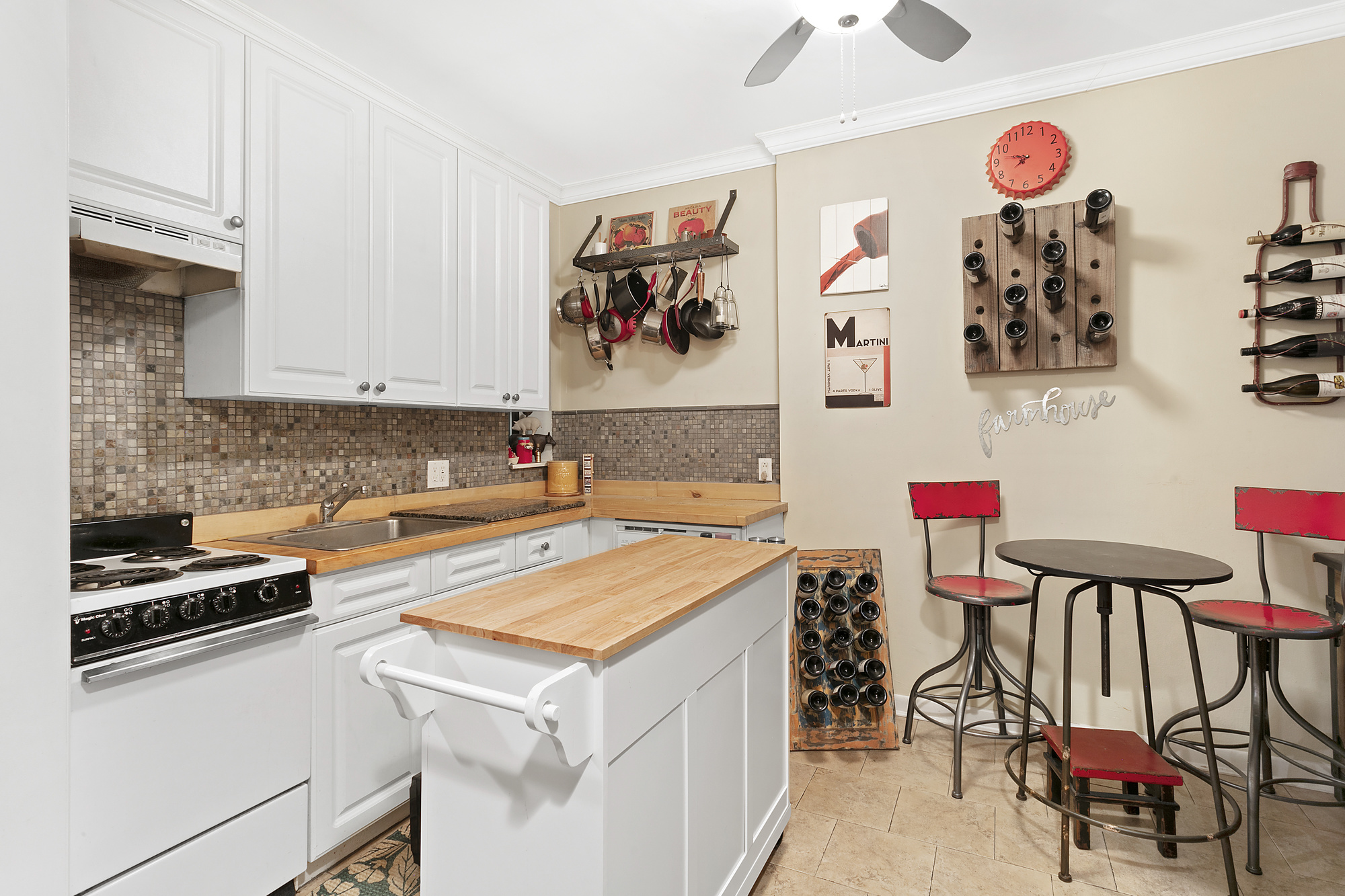 425 West 24th Street, Unit 1E Manhattan, NY 10011 - Photo 2 of 5 a kitchen with a cabinets and white appliances