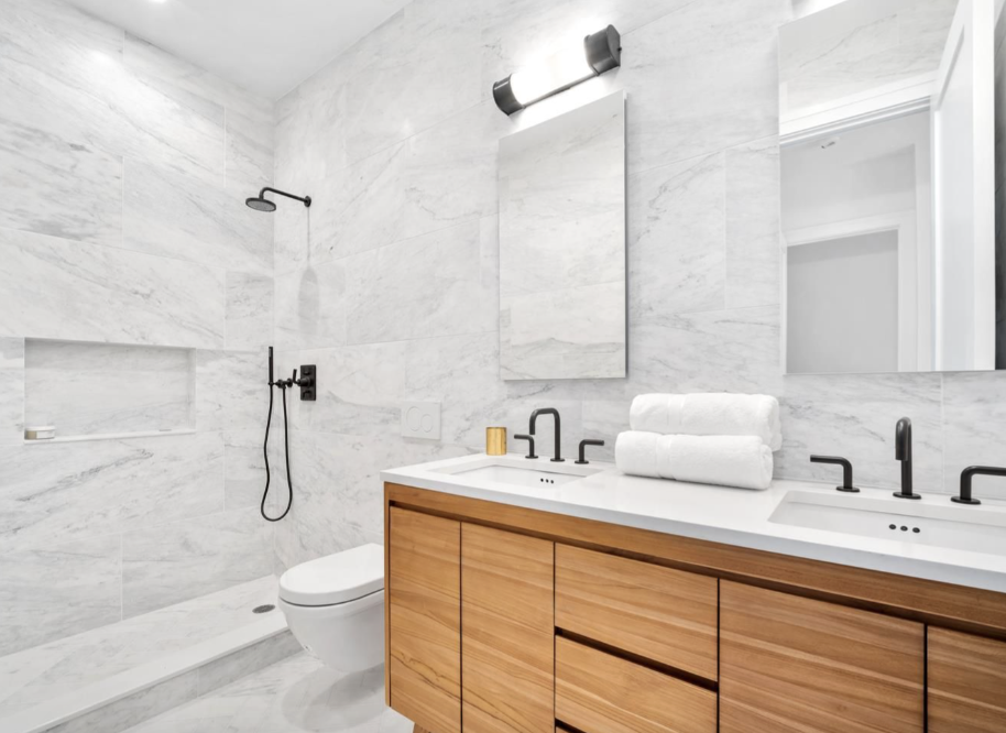 243 North 5th Street, Unit 2B Brooklyn, NY 11211 - Photo 9 of 14 a bathroom with a double vanity sink toilet and shower