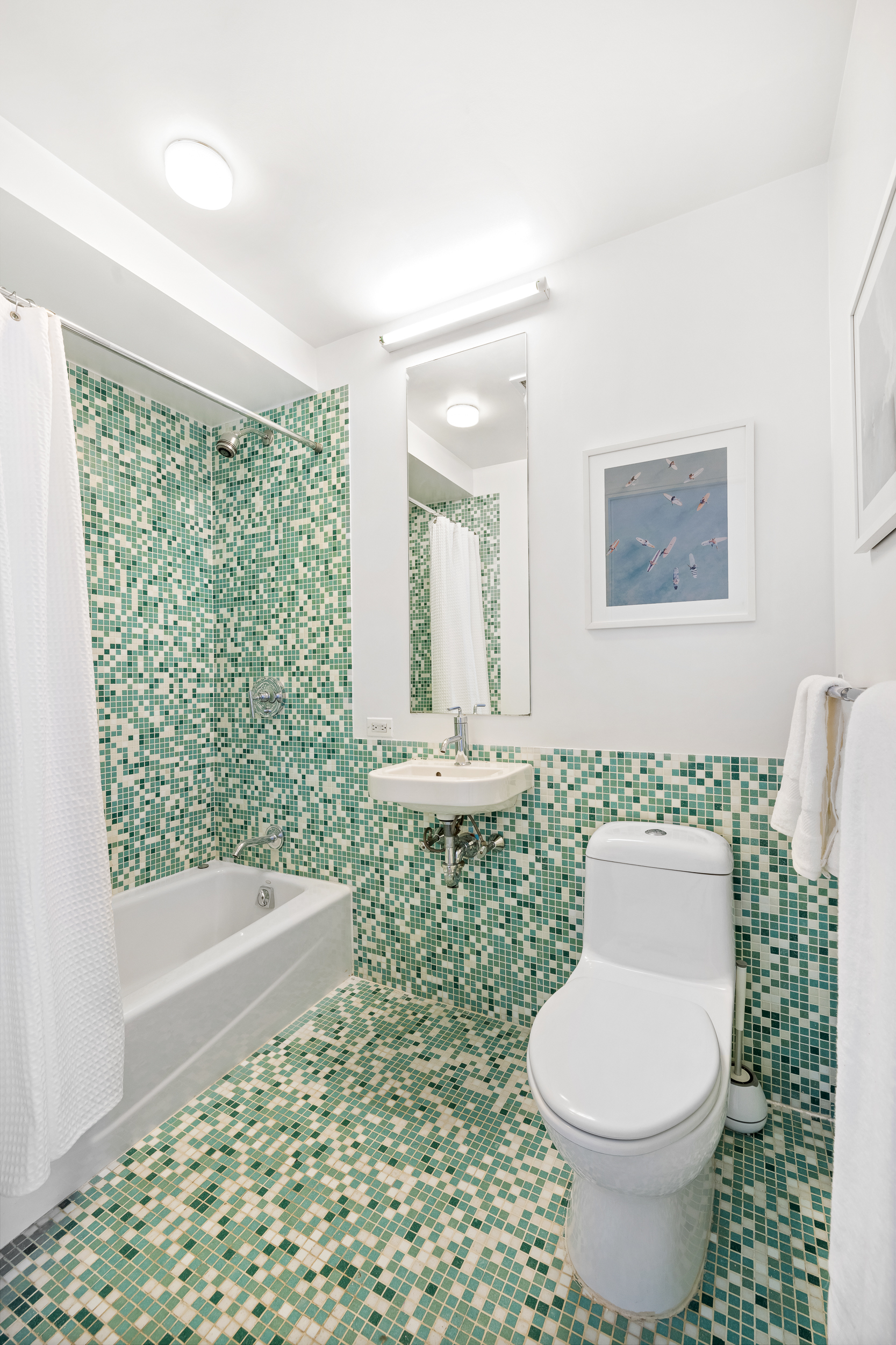 361 Manhattan Avenue, Unit 3AB Brooklyn, NY 11211 - Photo 14 of 21 a bathroom with a toilet a sink and a window