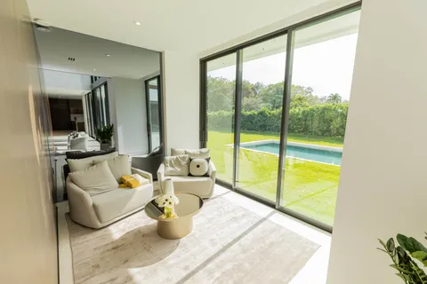 a living room with furniture and a floor to ceiling window