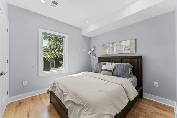 a bed sitting in a bedroom next to a window