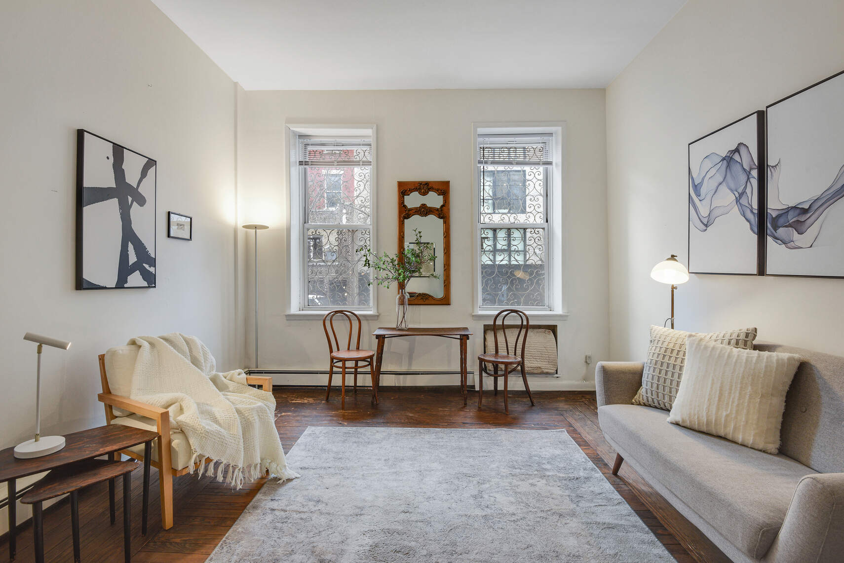 217 West 15th Street Manhattan, NY 10011 - Photo 15 of 21 a living room with furniture two window and a wooden floor