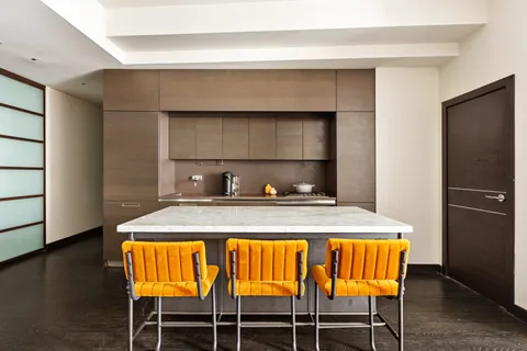 a kitchen with a table and chairs