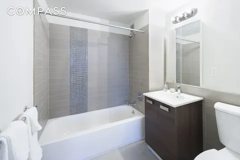 a bathroom with a sink mirror toilet and bathtub