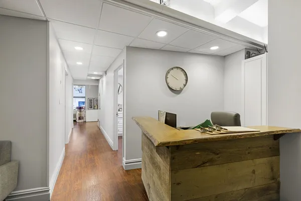a view of a room with wooden floor