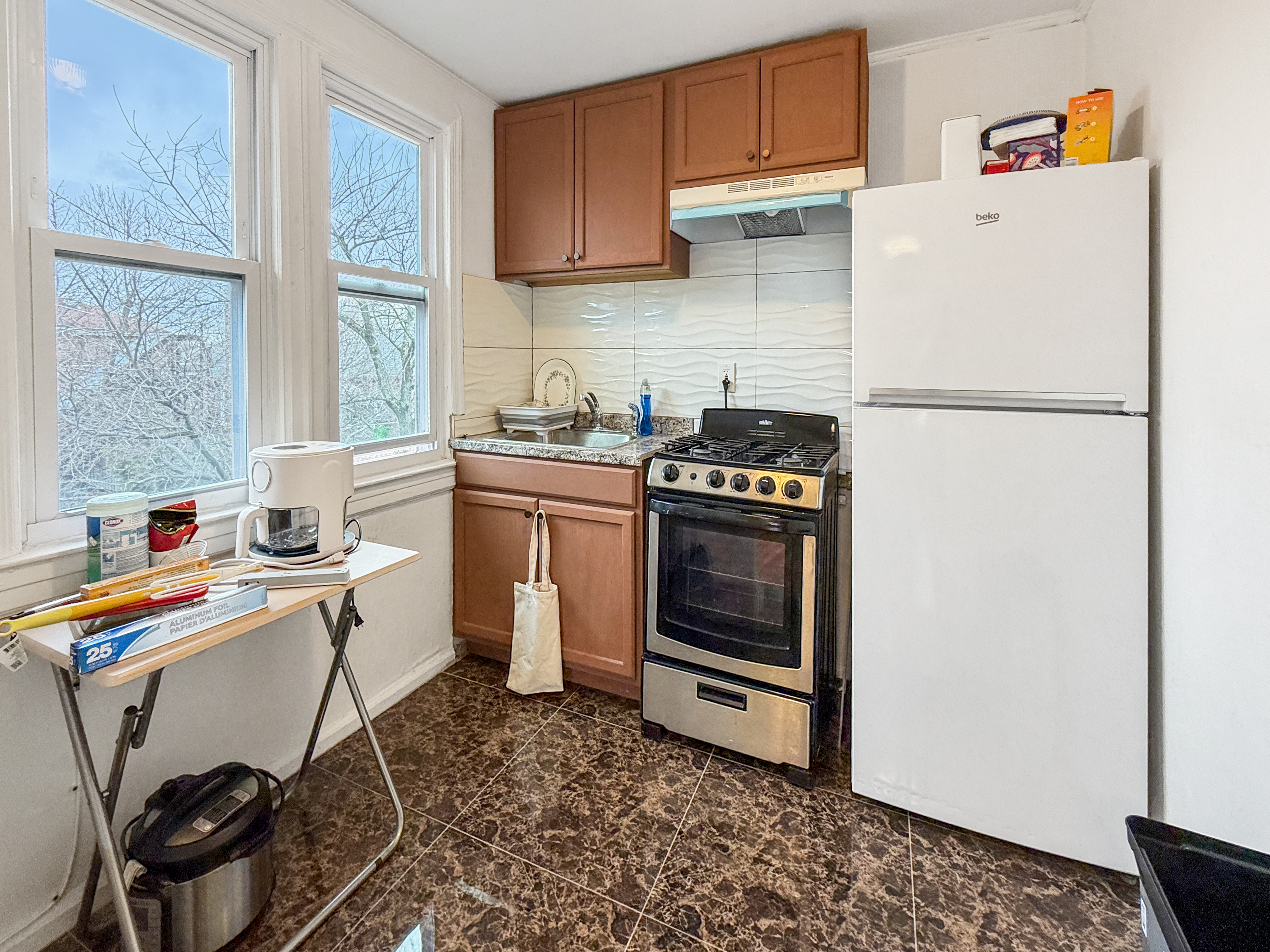 4215 Atlantic Avenue Brooklyn, NY 11224 - Photo 13 of 21 a kitchen with a stove and a refrigerator