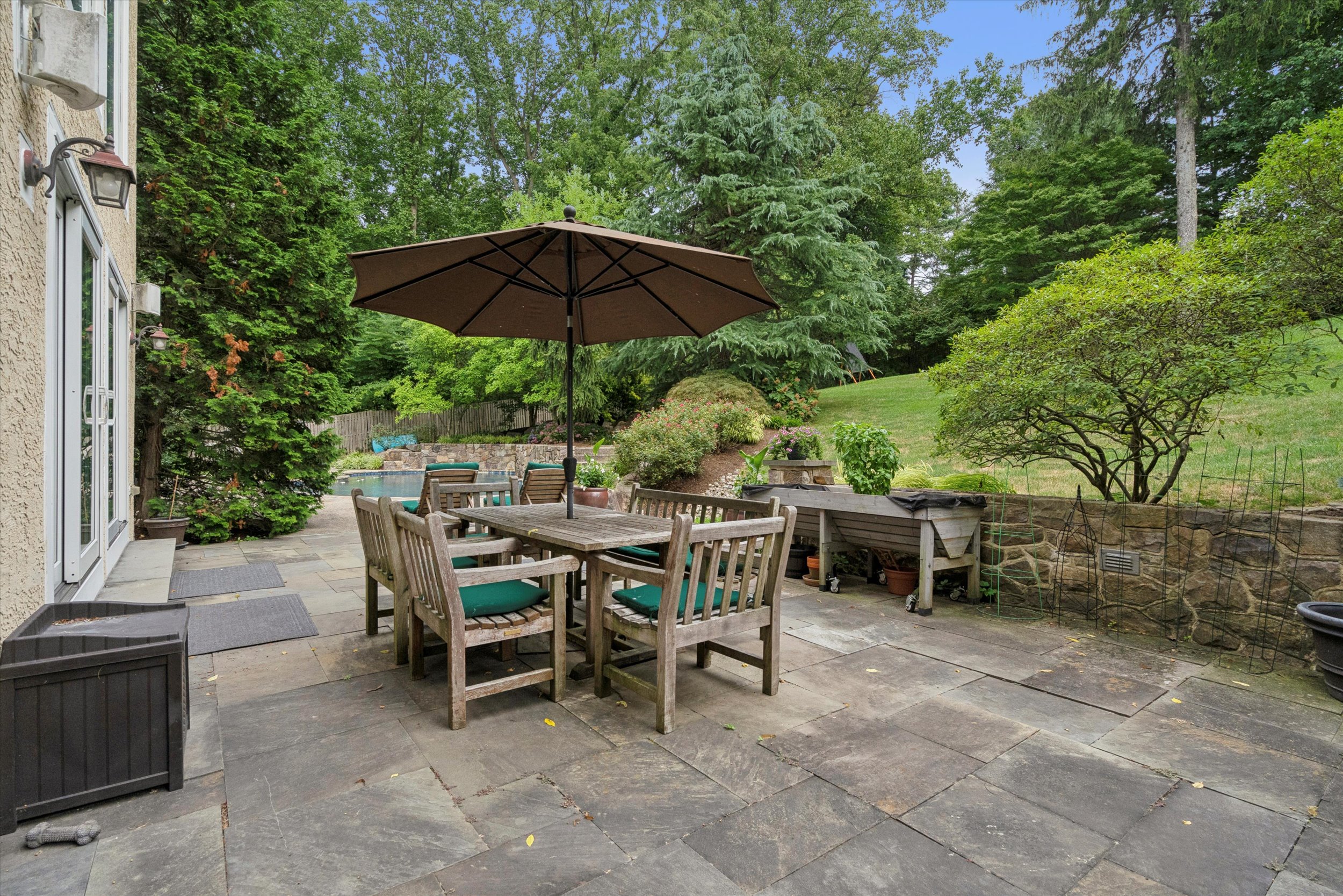 145 Biddulph Road Wayne, PA 19087 - Photo 37 of 39 a view of a backyard with furniture and a table