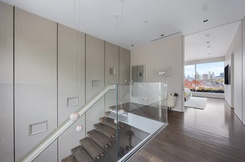a view of living room with furniture and wooden floor
