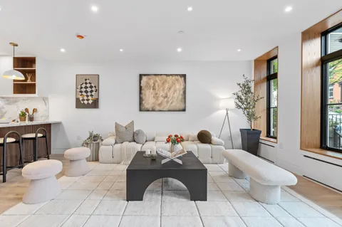 a living room with furniture and a potted plant