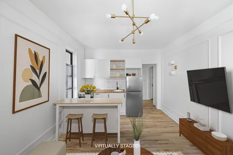 a kitchen with stainless steel appliances kitchen island granite countertop a refrigerator and a stove top oven