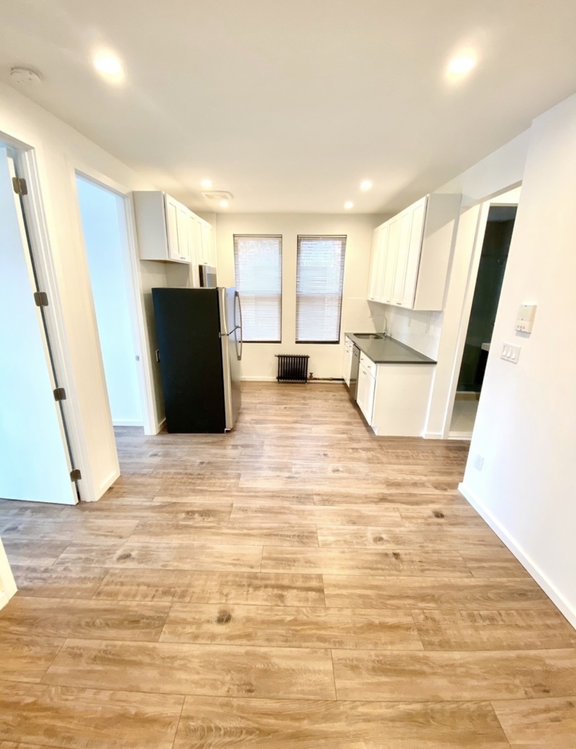 31-14 36th Street, Unit 3F Queens, NY 11106 - Photo 3 of 11 a view of a refrigerator in kitchen and an empty room