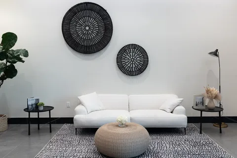 a living room with furniture a rug and a chair