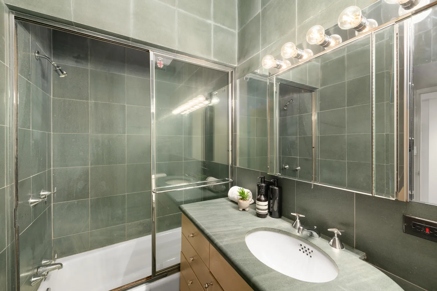 a bathroom with a double vanity sink mirror and shower