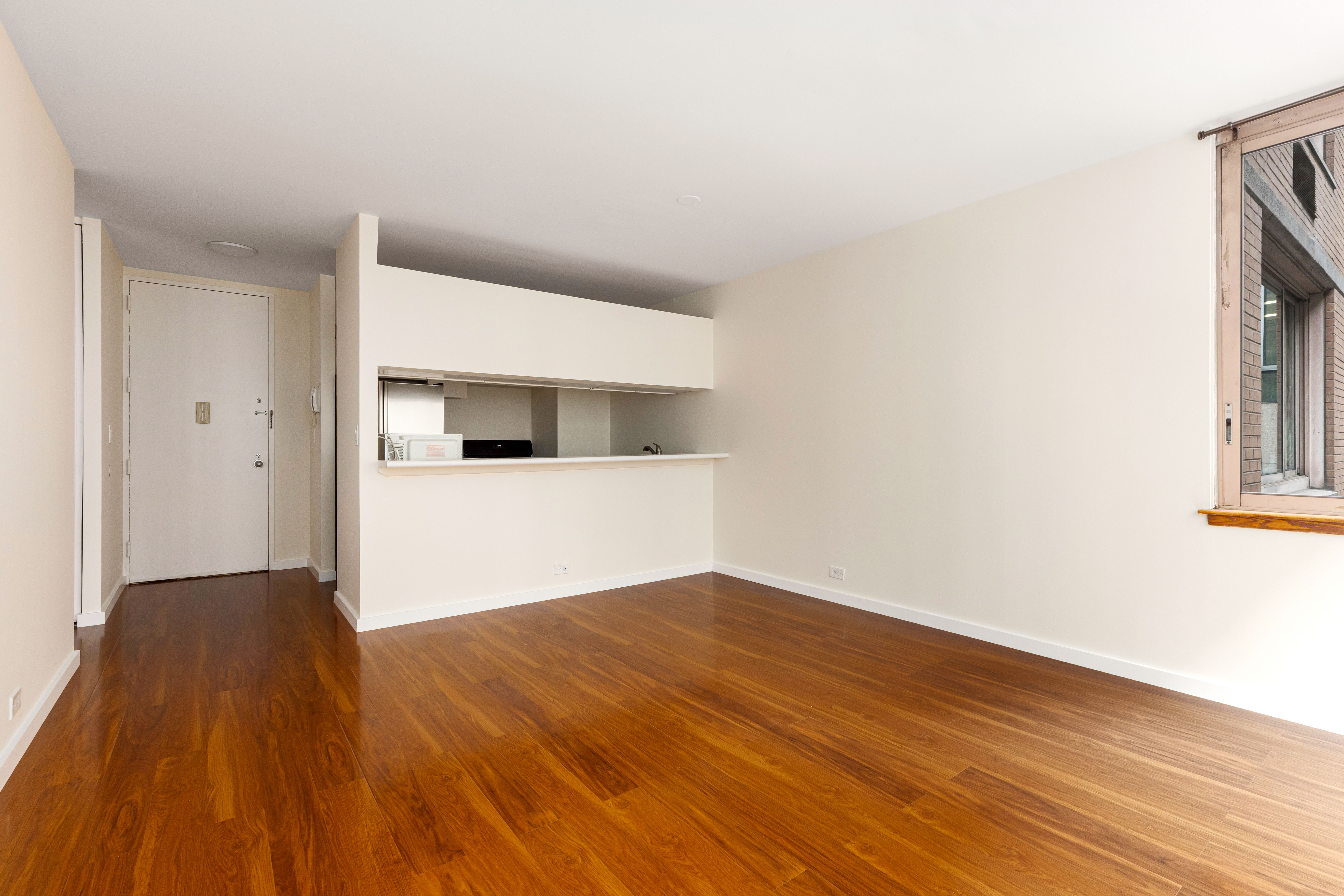 235 East 40th Street, Unit 4E Manhattan, NY 10016 - Photo 2 of 6 a view of a room with wooden floor
