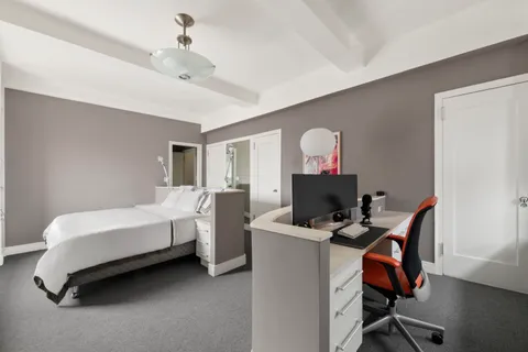 a bed room with a bed and a chandelier