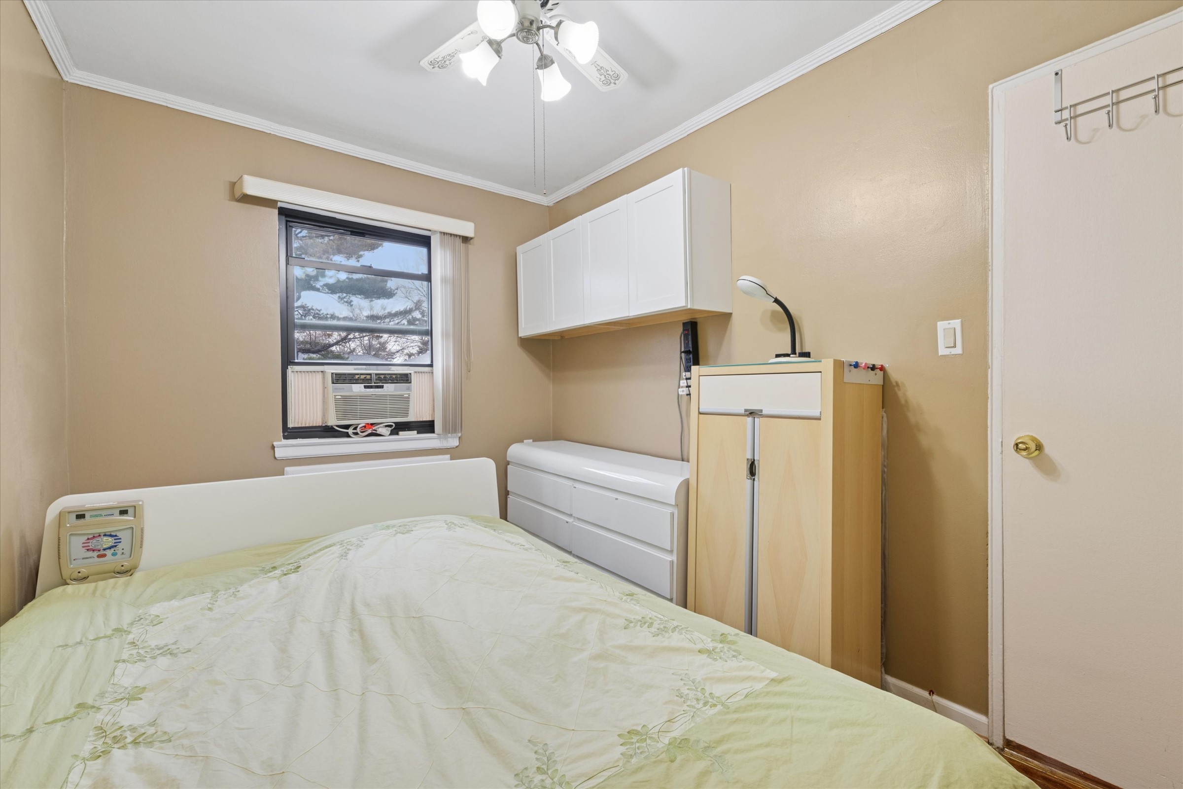 74-22 220th Street Oakland Garden, NY 11364 - Photo 11 of 16 a bedroom with a bed and a chandelier