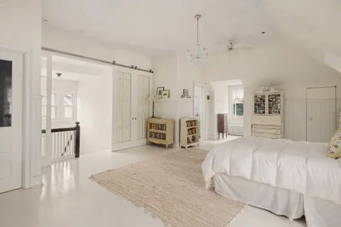 a spacious bedroom with a bed and a cabinets