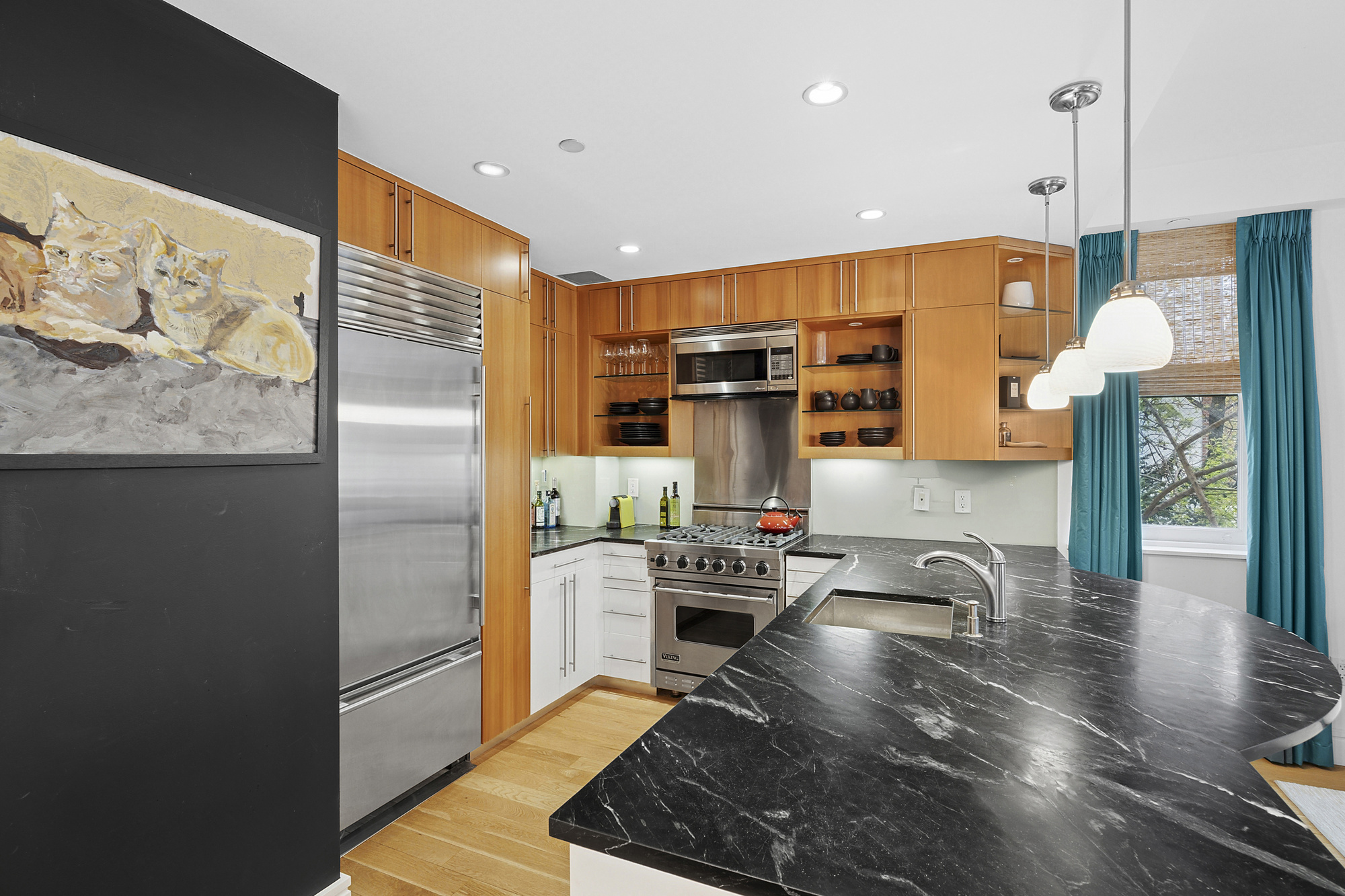 331 East 8th Street, Unit 2 Manhattan, NY 10009 - Photo 2 of 12 a kitchen with stainless steel appliances granite countertop a sink stove and refrigerator