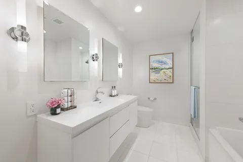 a bathroom with a sink mirror and vanity