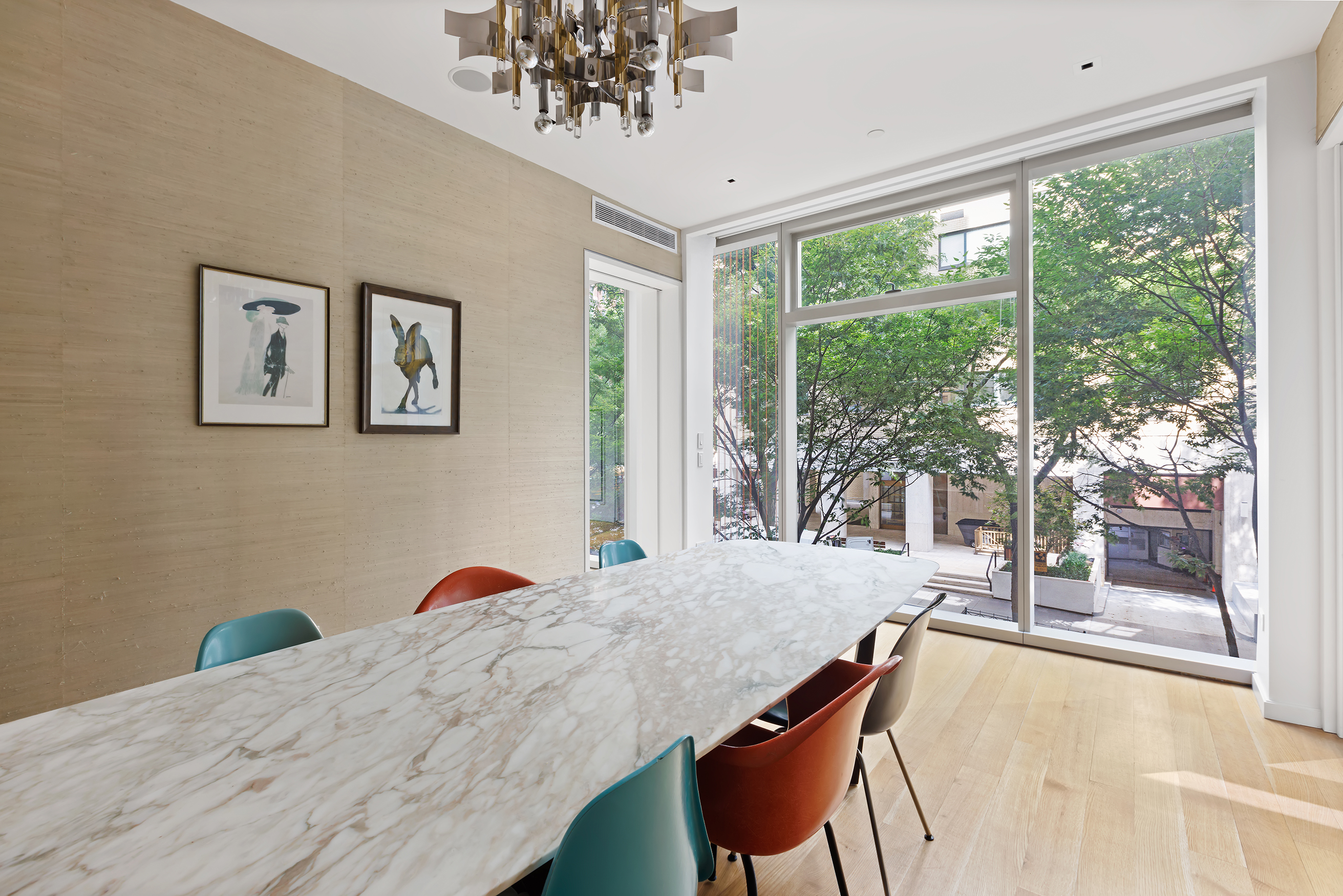 1055 Park Avenue, Unit 1 Manhattan, NY 10028 - Photo 8 of 19 a view of a dining room with furniture large windows and wooden floor