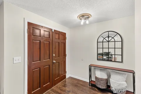 a view of front door with wooden floor
