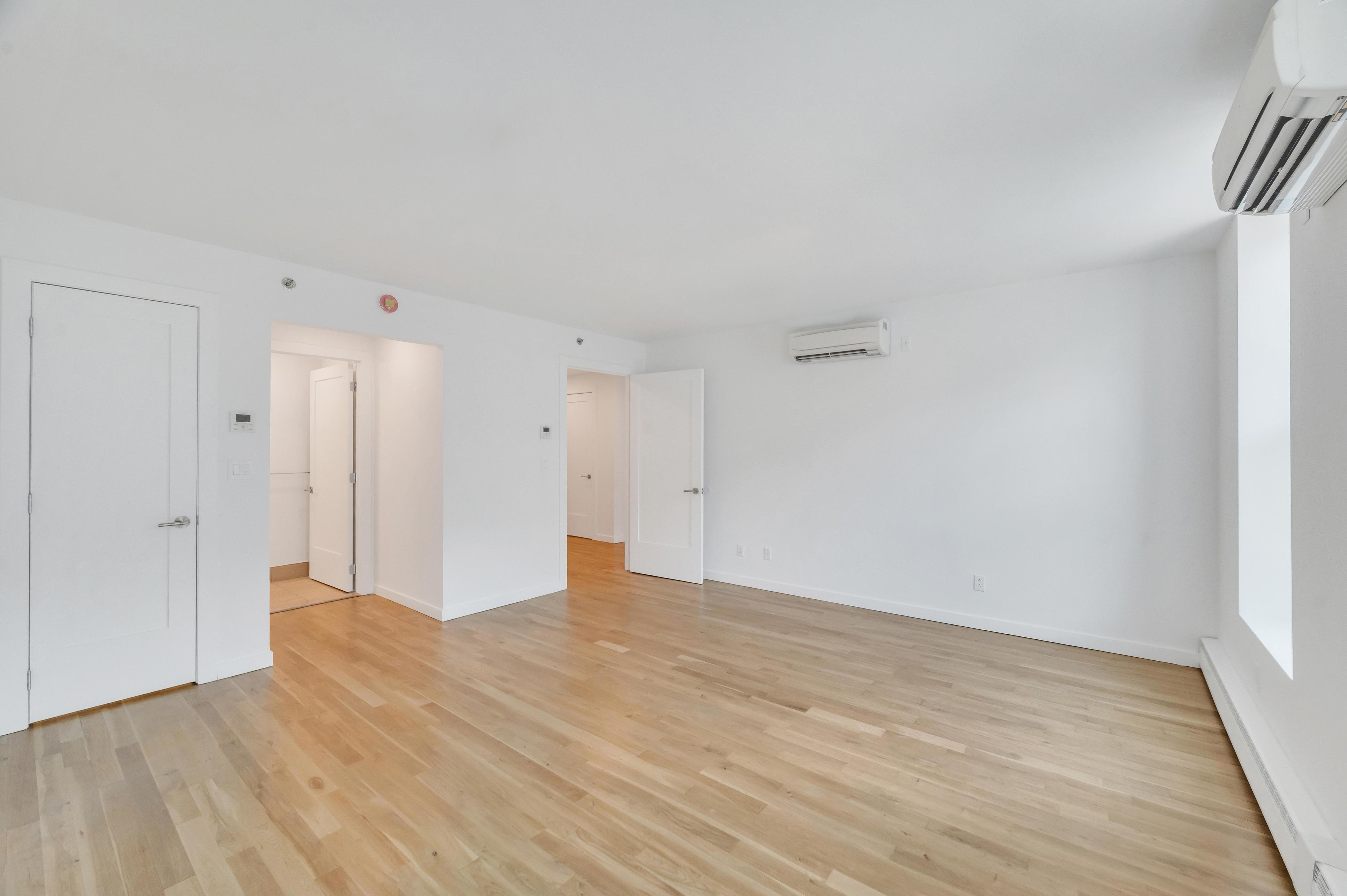 717 Manhattan Avenue, Unit 3A Brooklyn, NY 11222 - Photo 7 of 18 a view of empty room with wooden floor and fan