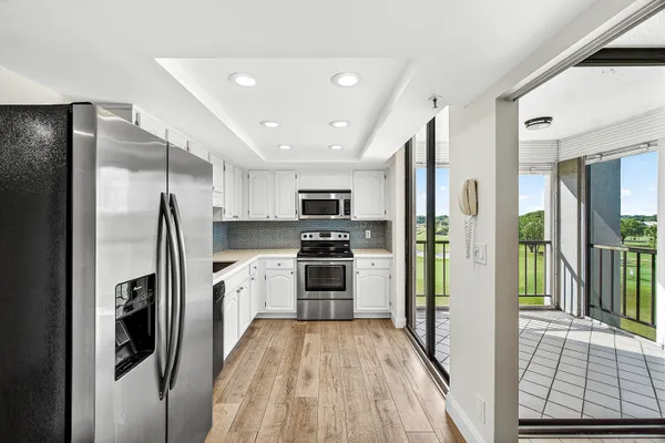 a kitchen with stainless steel appliances a refrigerator and a stove top oven
