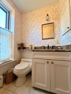 a bathroom with a toilet a sink and a window