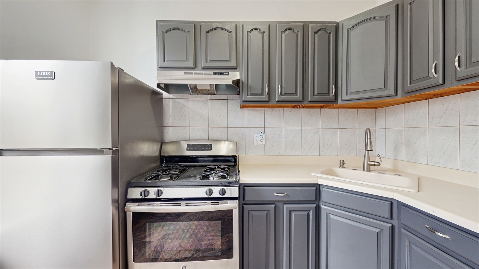 454 77th Street, Unit 3 Brooklyn, NY 11209 - Photo 4 of 25 a kitchen with stainless steel appliances a stove a refrigerator and cabinets