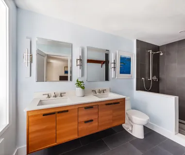 a bathroom with a toilet a sink and mirror