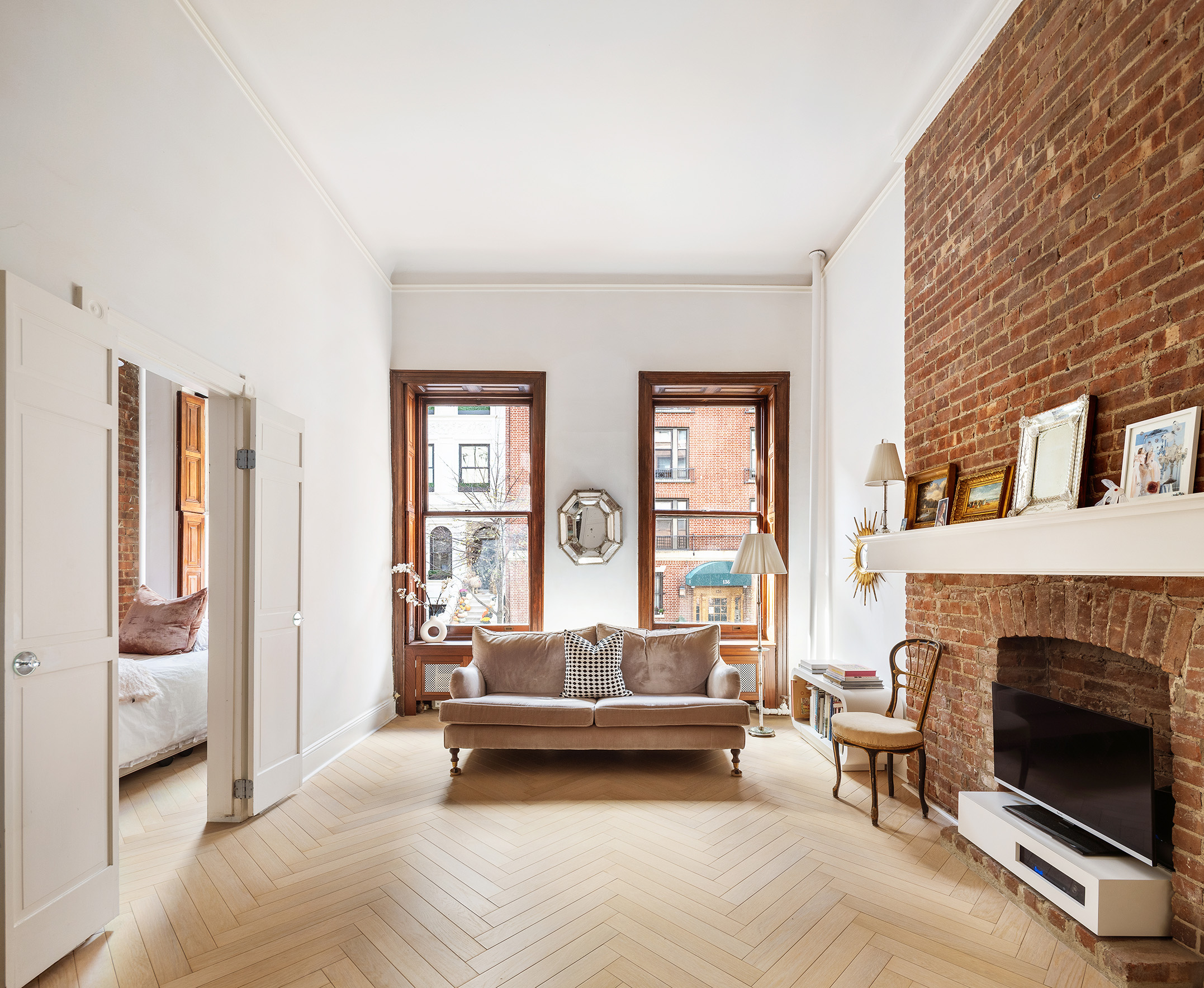 133 West 75th Street, Unit PARLOUR A Manhattan, NY 10023 - Photo 4 of 11 a living room with furniture and a fireplace