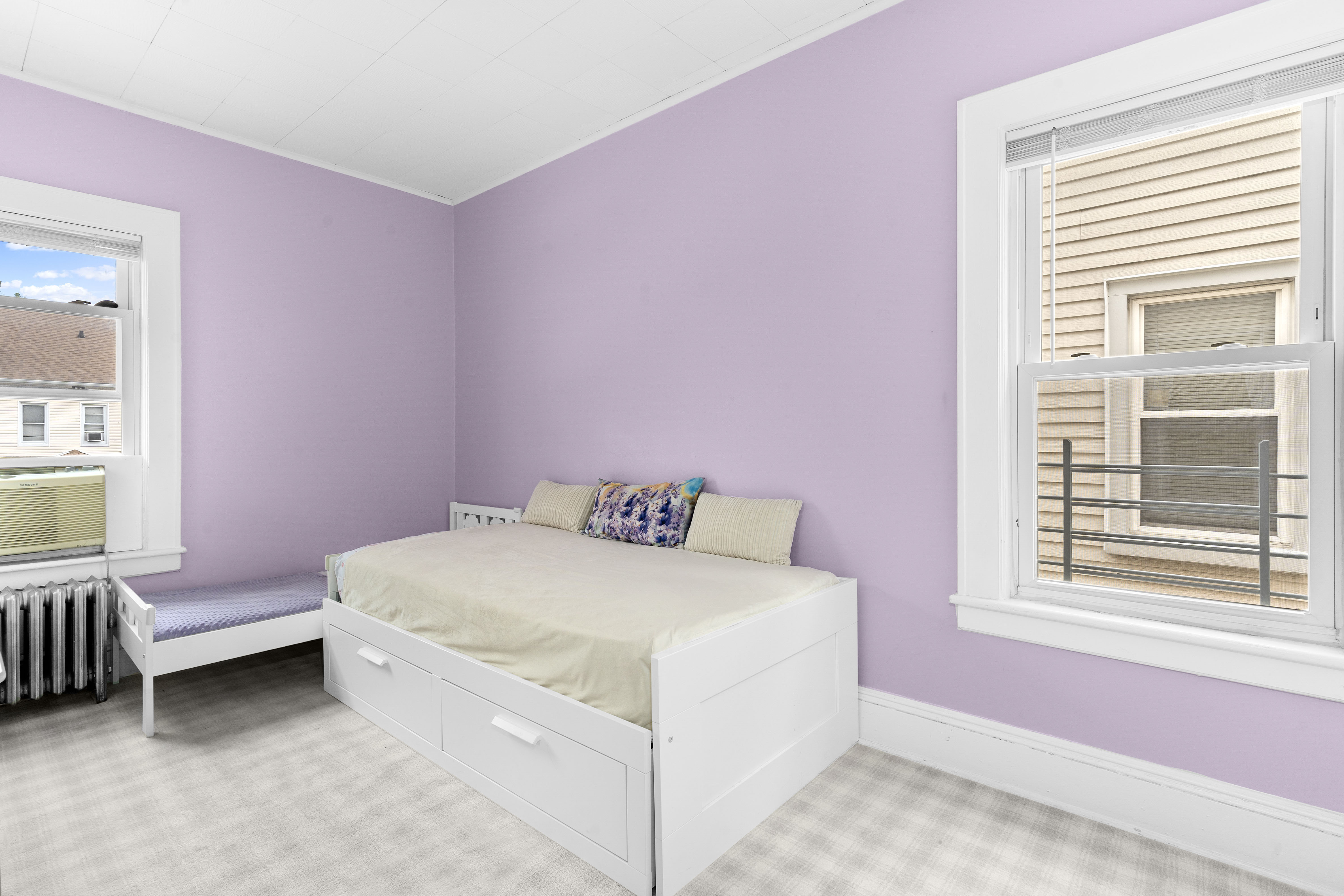 1065 East 39th Street Brooklyn, NY 11210 - Photo 4 of 15 a bedroom with a bed and a window