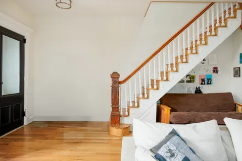 a view of entryway and hall with wooden floor