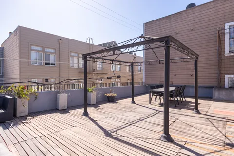 a roof deck view with a seating space
