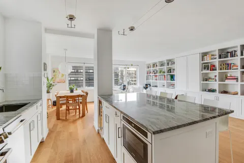 a kitchen with stainless steel appliances granite countertop stove top oven and cabinets