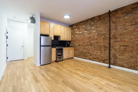 a view of a kitchen with wooden floor