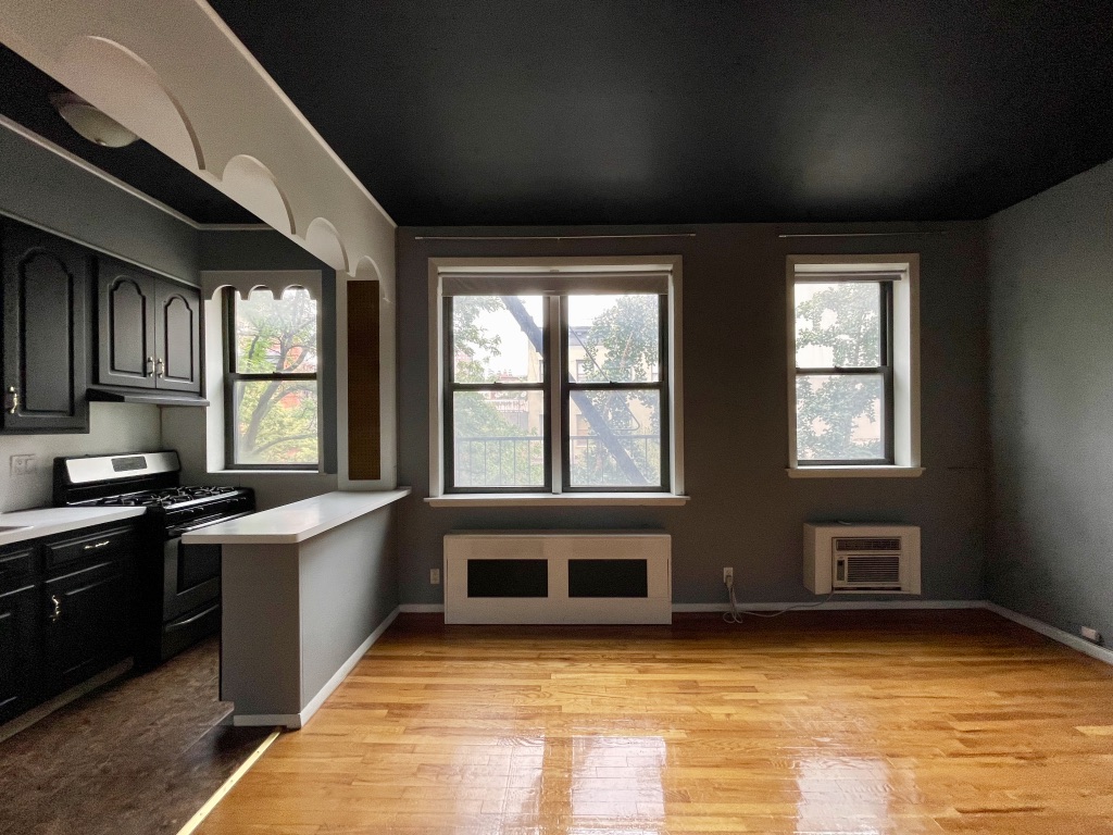 266 West 22nd Street, Unit 2 Manhattan, NY 10011 - Photo 4 of 14 a view of a kitchen with a sink cabinets and a window