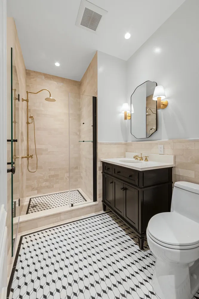 a bathroom with a sink a toilet and shower