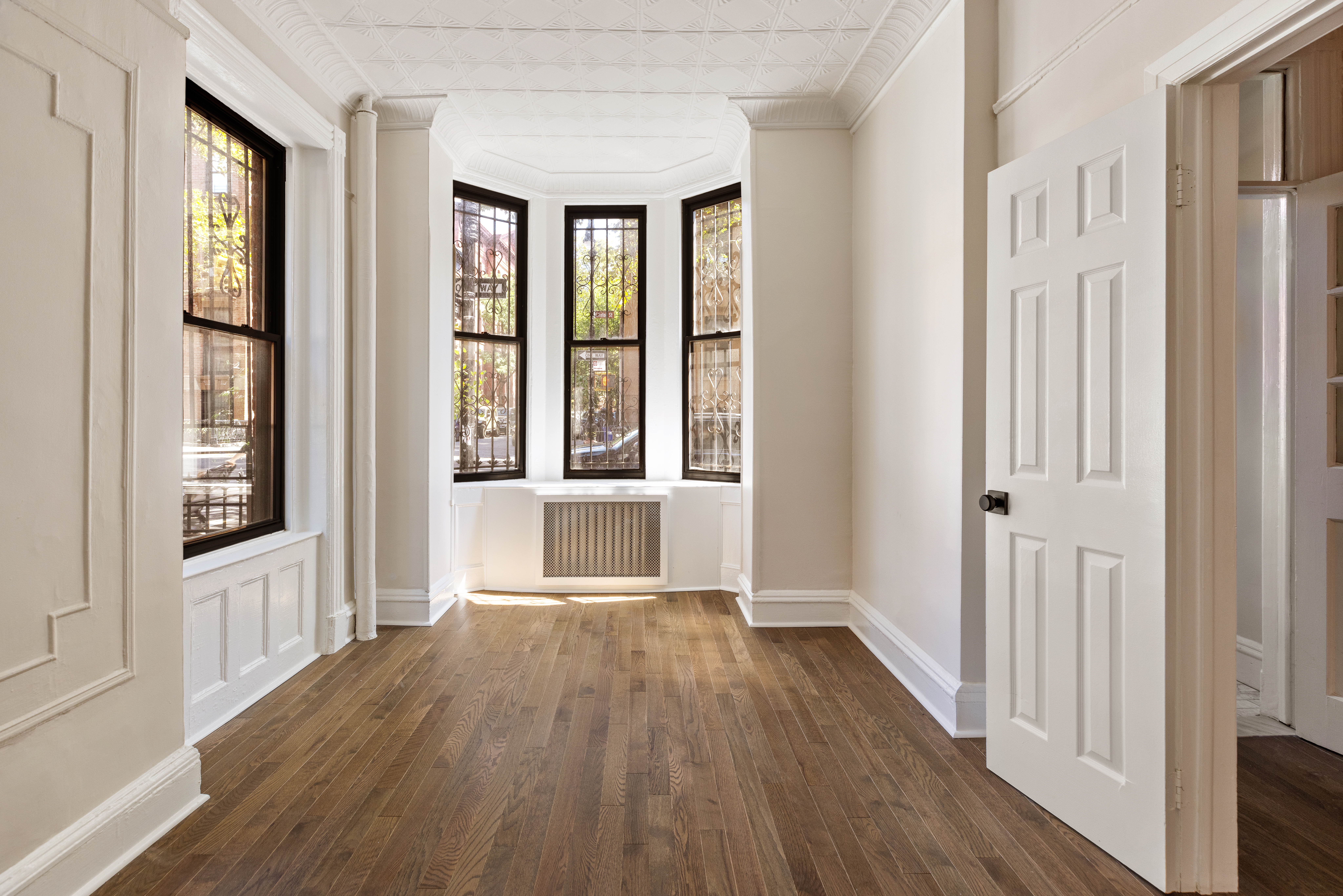 280 Clinton Street, Unit 1 Brooklyn, NY 11201 - Photo 2 of 11 wooden floor in an empty room with a window