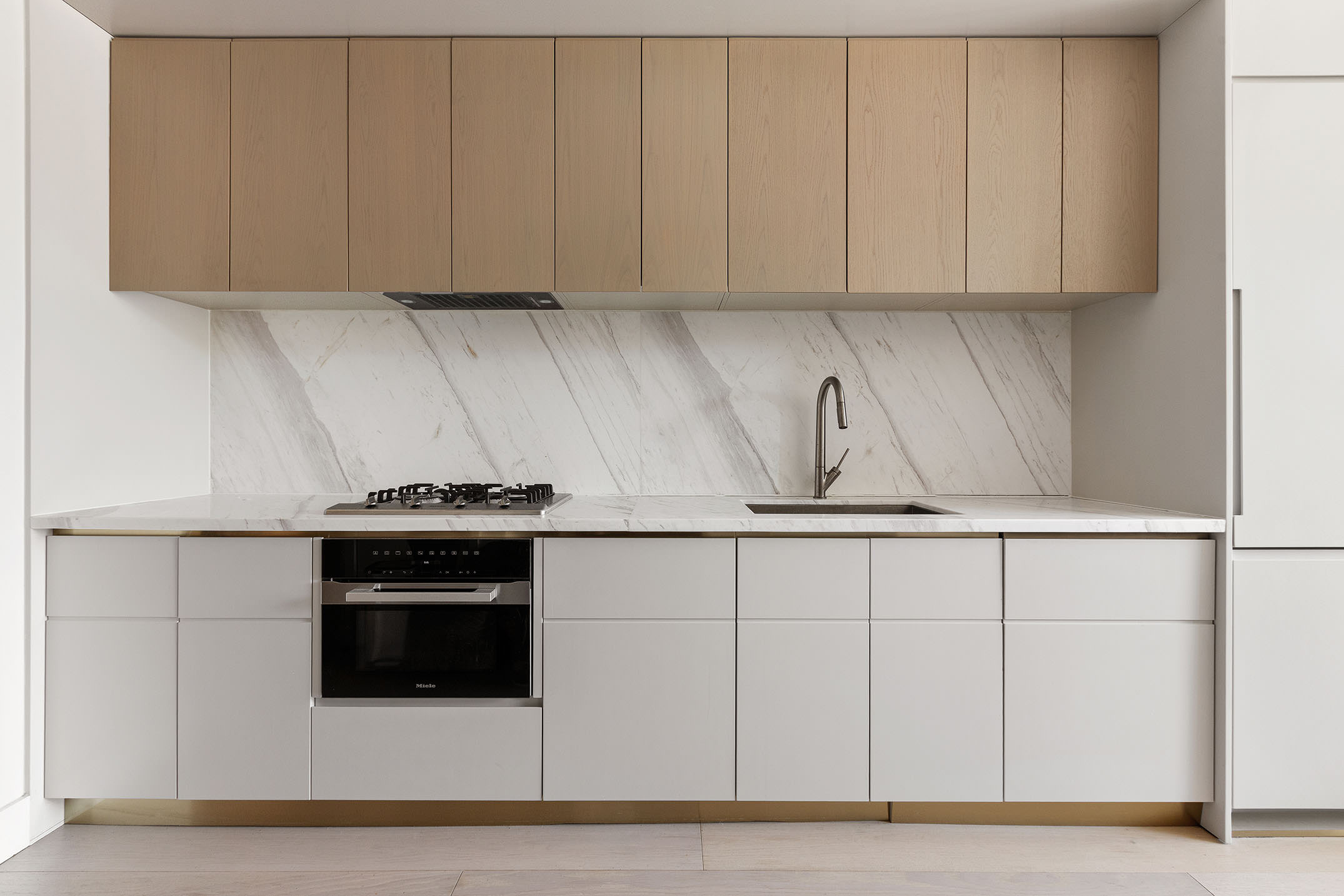 208 Delancey Street, Unit 3A Manhattan, NY 10002 - Photo 3 of 7 a kitchen with stainless steel appliances granite countertop white cabinets and a sink