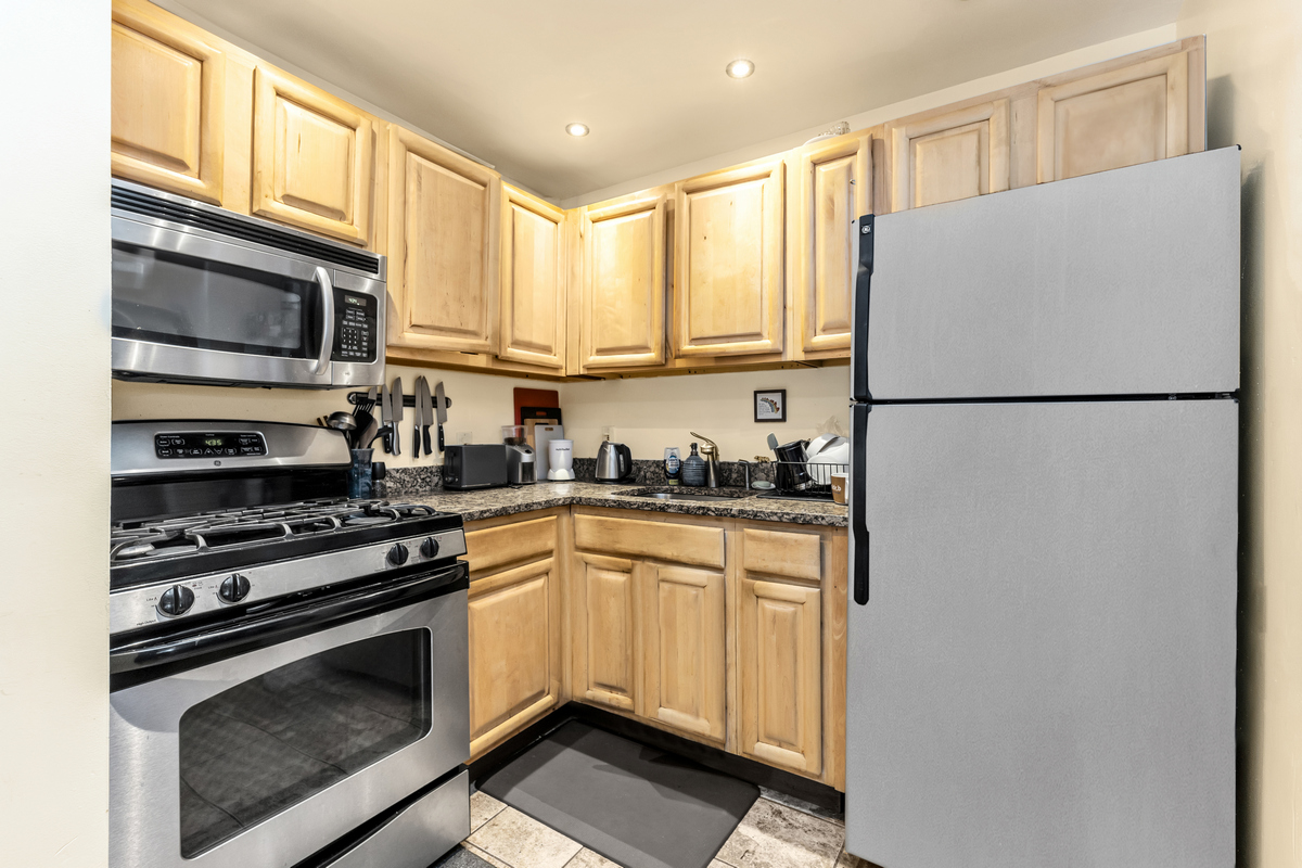 539 Quincy Street Brooklyn, NY 11221 - Photo 5 of 15 a kitchen with stainless steel appliances a refrigerator sink and microwave