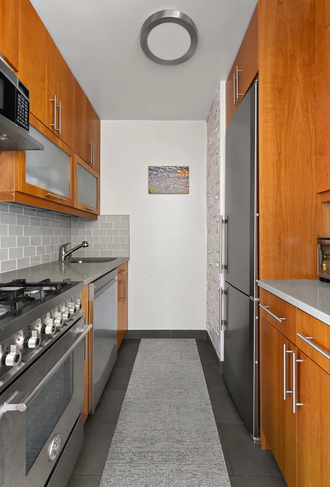 a kitchen with granite countertop a stove and a refrigerator