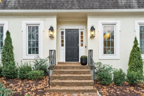 a front view of a house with a garden