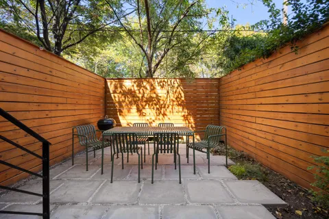 a view of two chairs in the patio